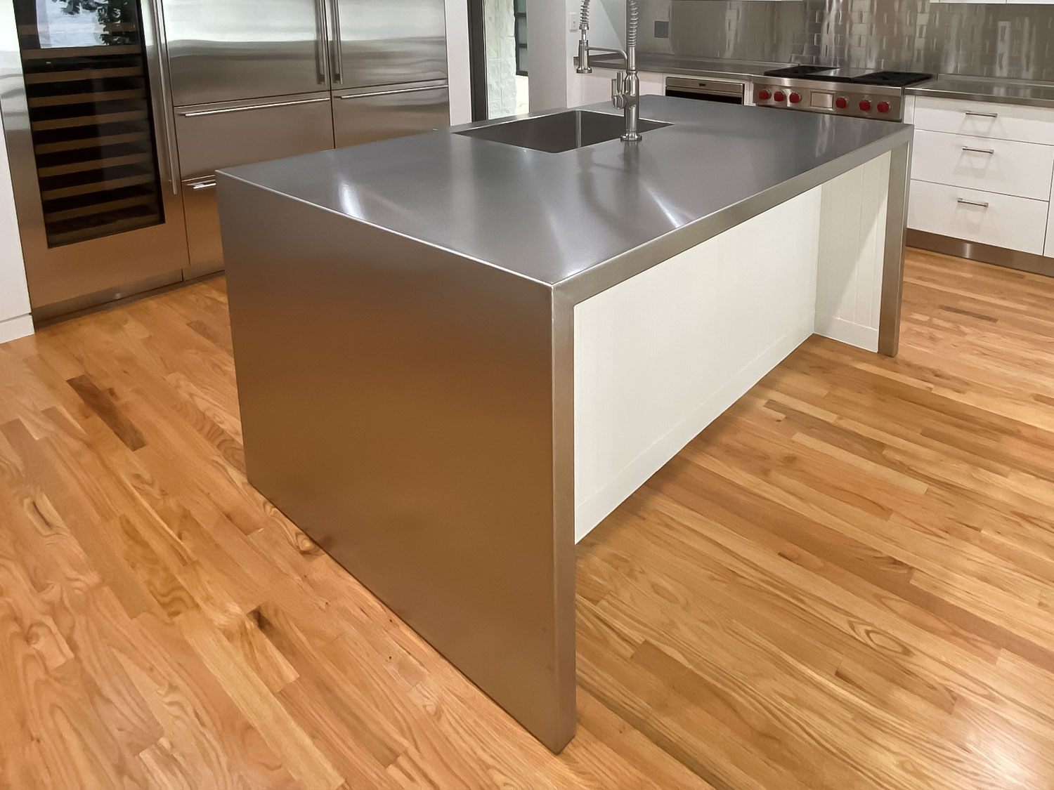 Stainless Steel Countertops with Integrated Stainless Steel Sink and Waterfall Edge